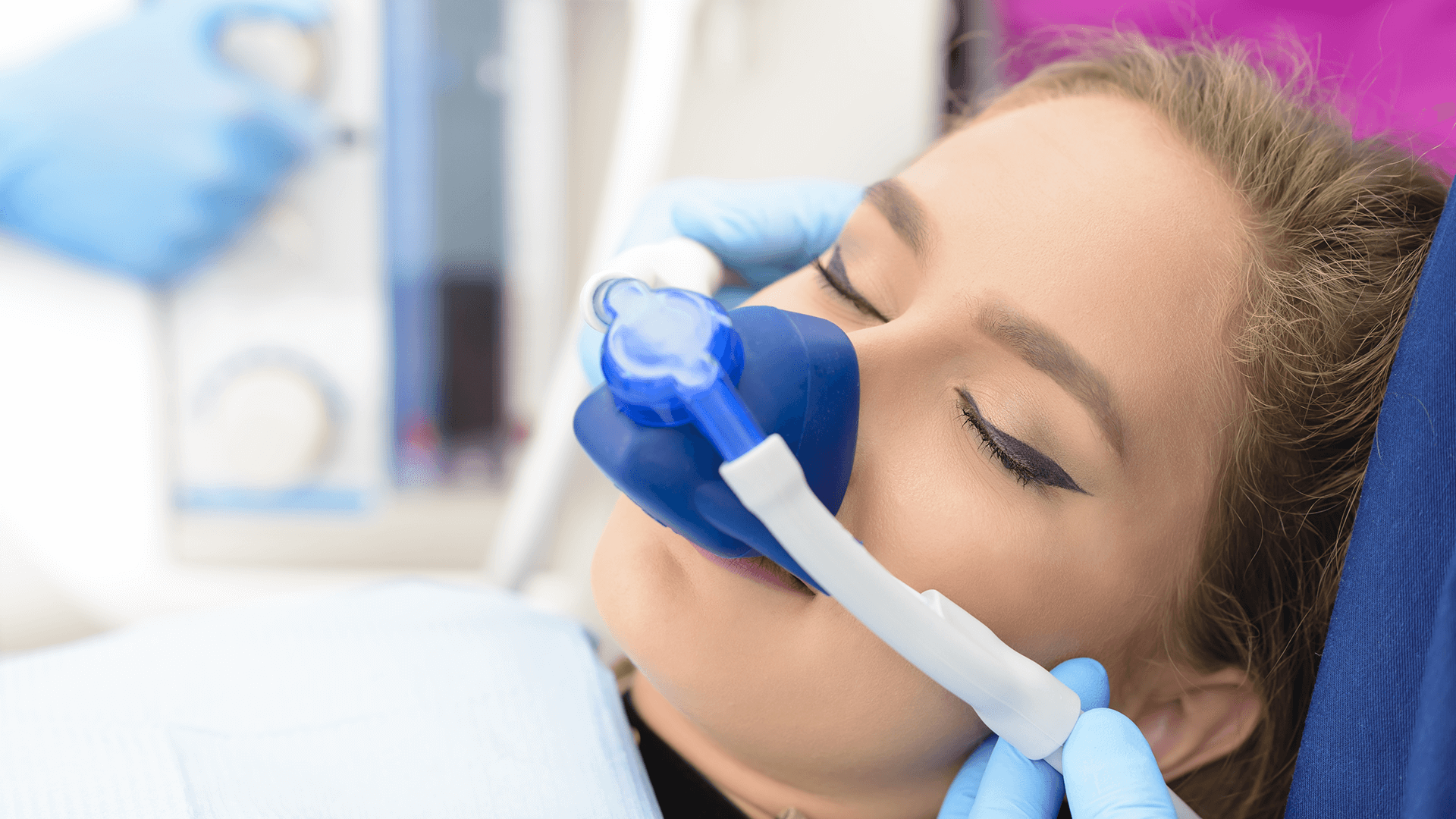 Woman with sedation mask on.