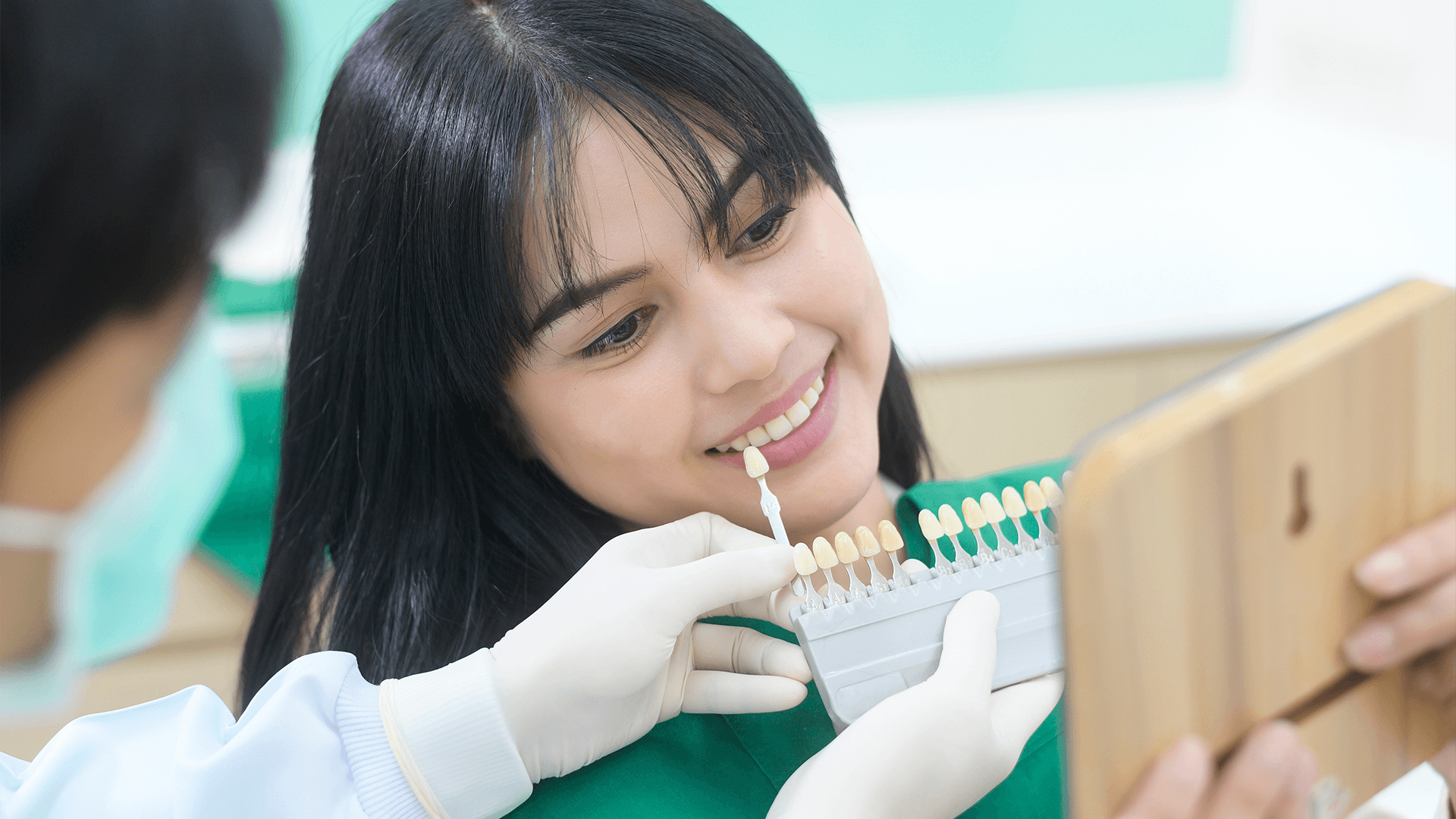Woman looking at different denture colors.