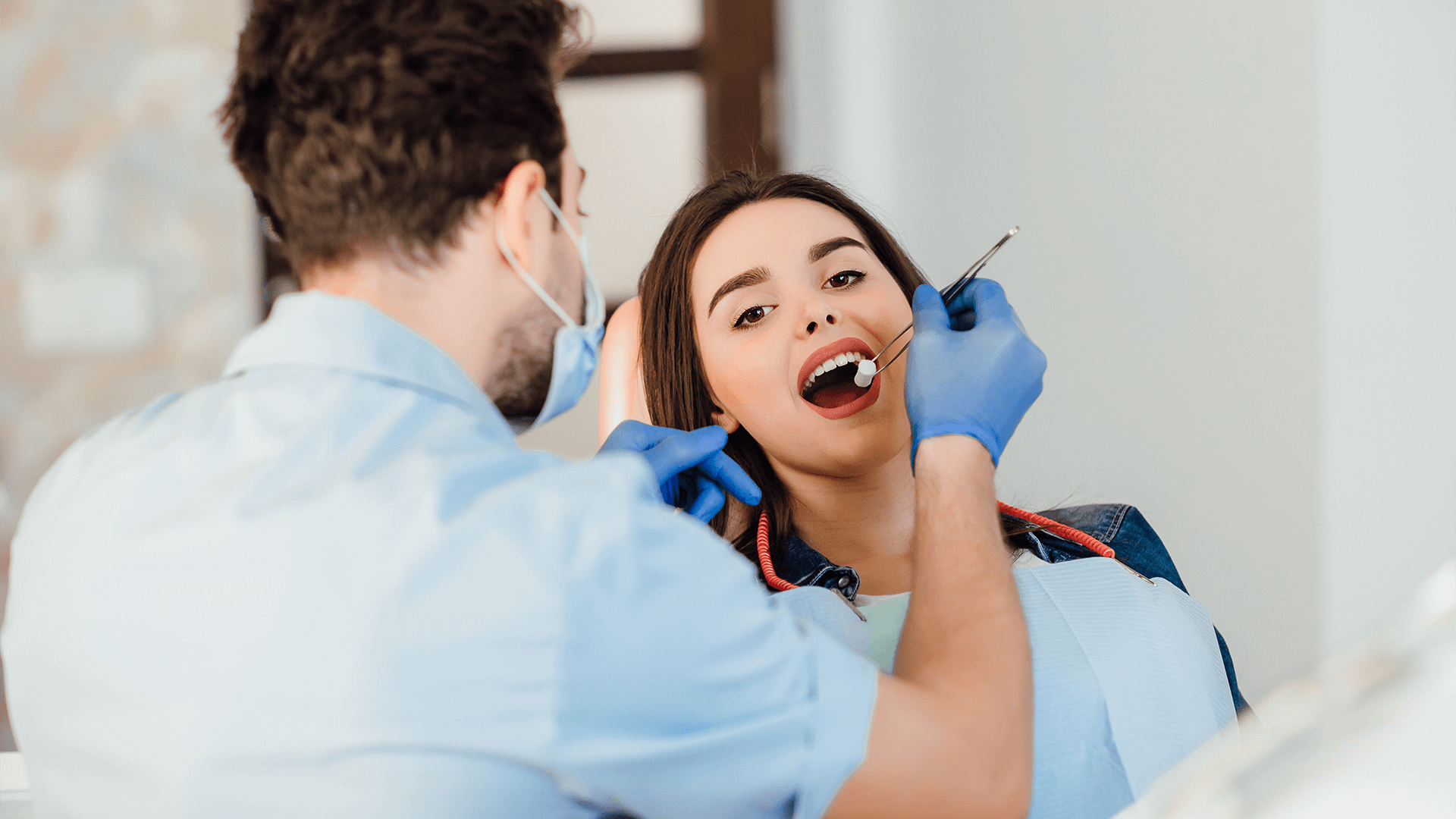 Dentist cleaning a woman's teeth.