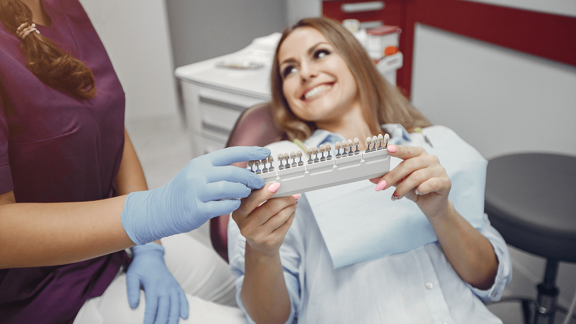 Woman looking at different denture colors.