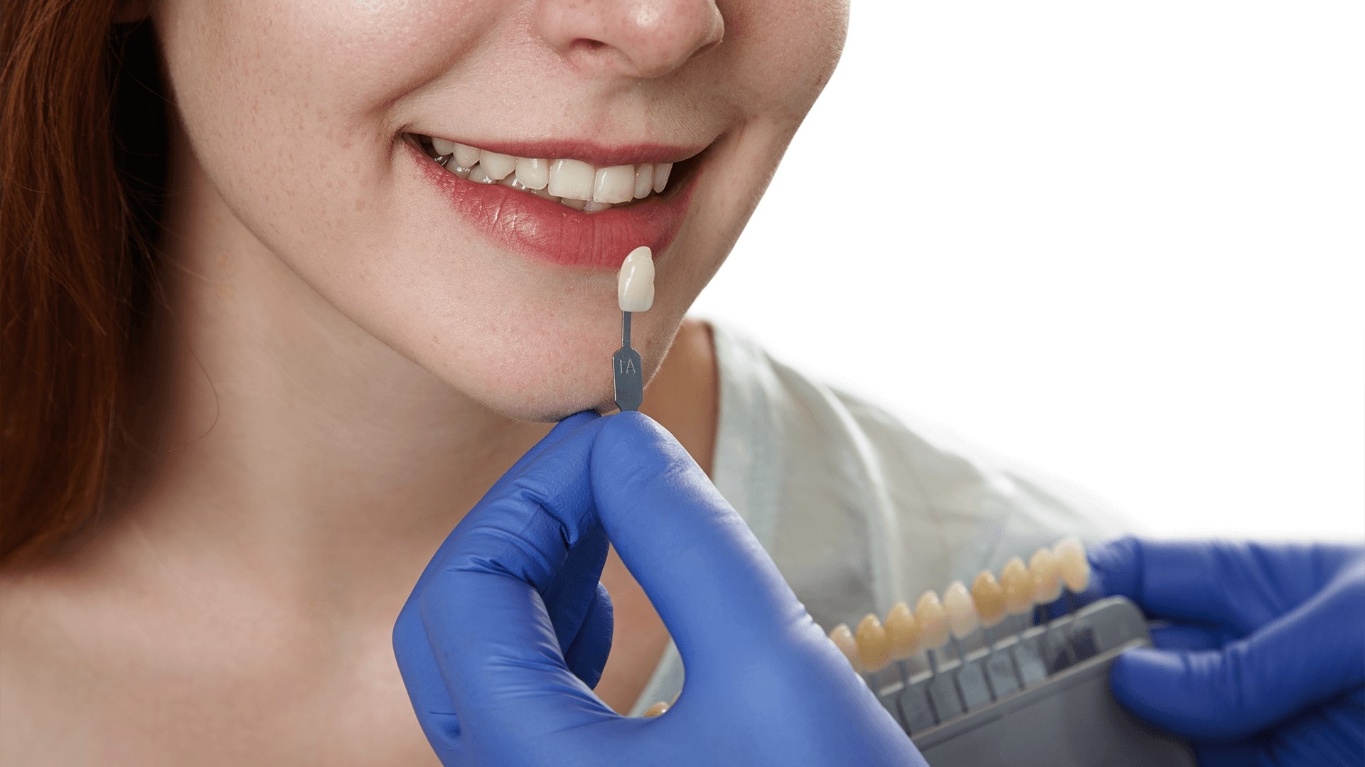 Dentist looking at tooth color in woman's smile.